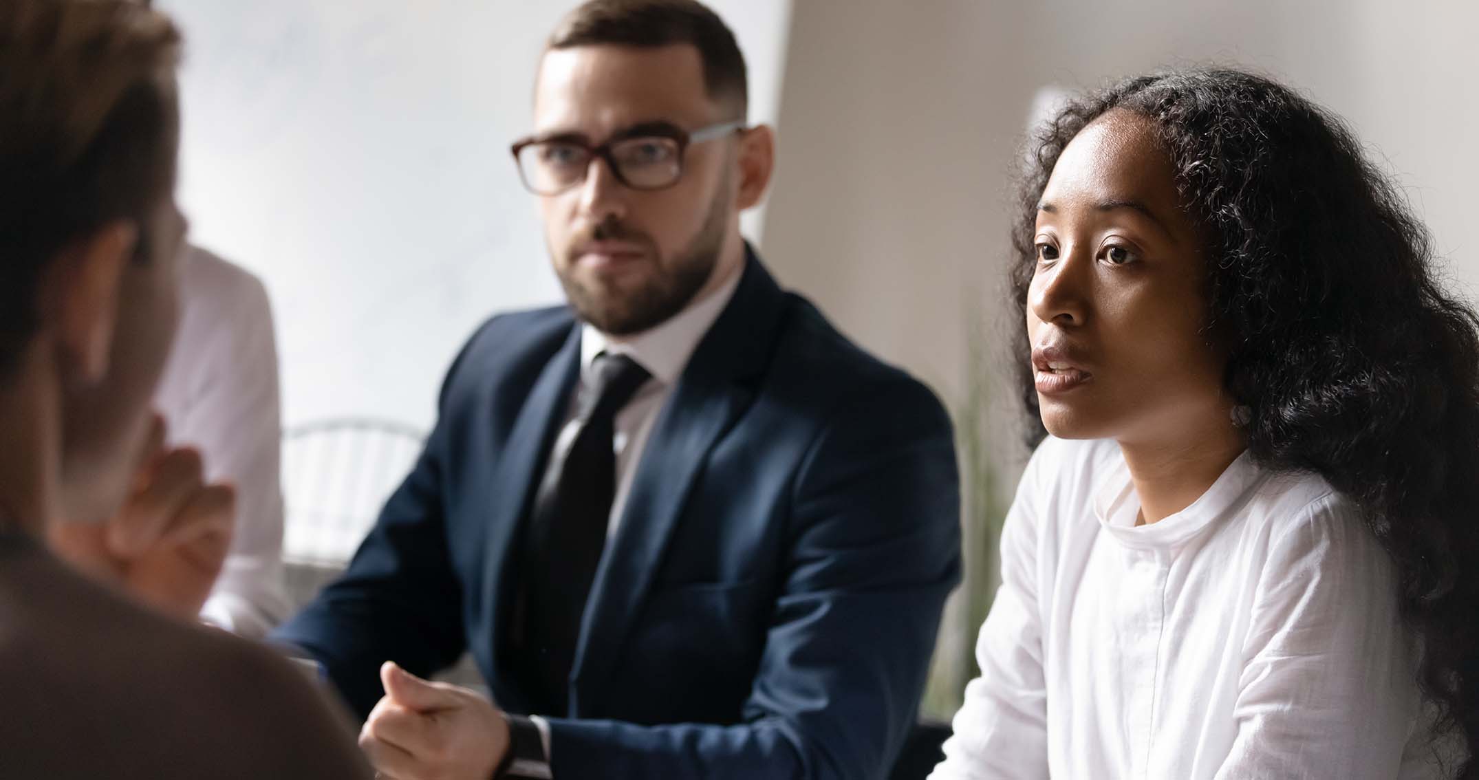 People discussing something serious in meeting room