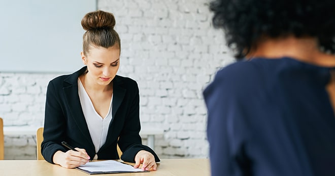 Woman signing an employment contract