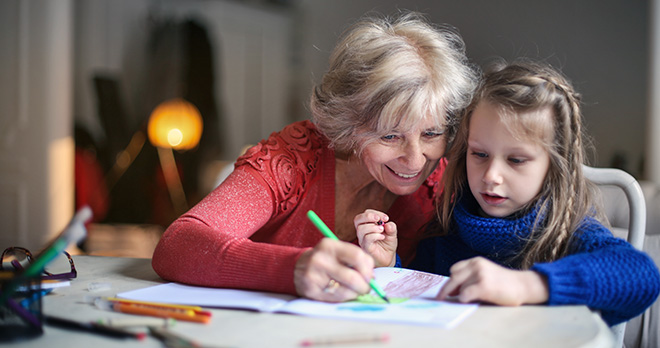 Grandmother with granddaughter doing art