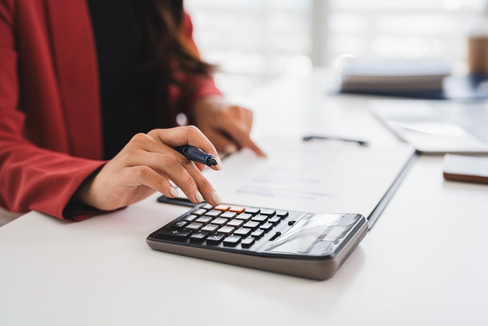 Person using a calculator to calculate future loss in a personal injury compensation claim