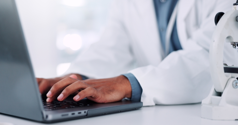 Medical expert typing a report for a serious injury claim